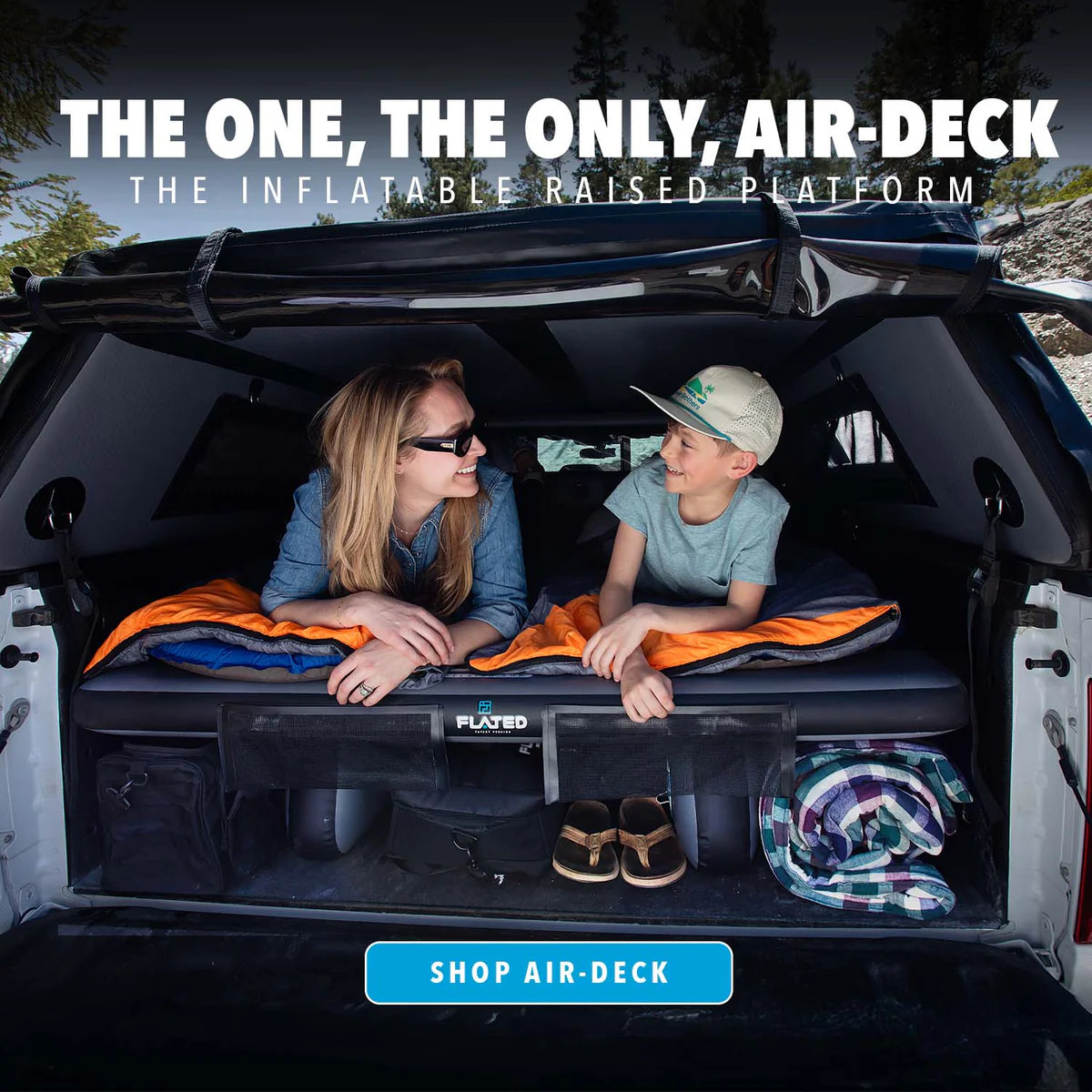 Two people sitting in an open car trunk with an inflatable raised platform, promotional text, and 'Shop Air-Deck' button.